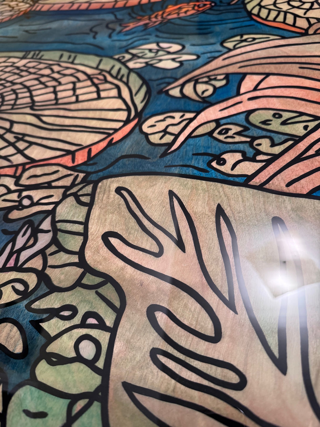 Detail — birch wood grain showing through translucent color on the leaves and pond